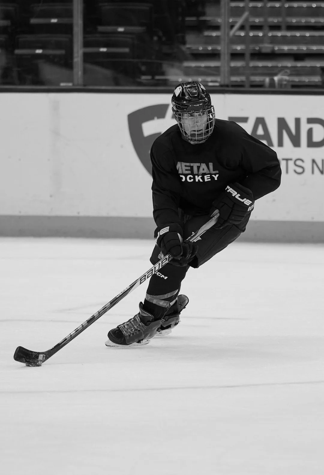 Rick Scott skating with the puck on the ice at Crypto.com Arena