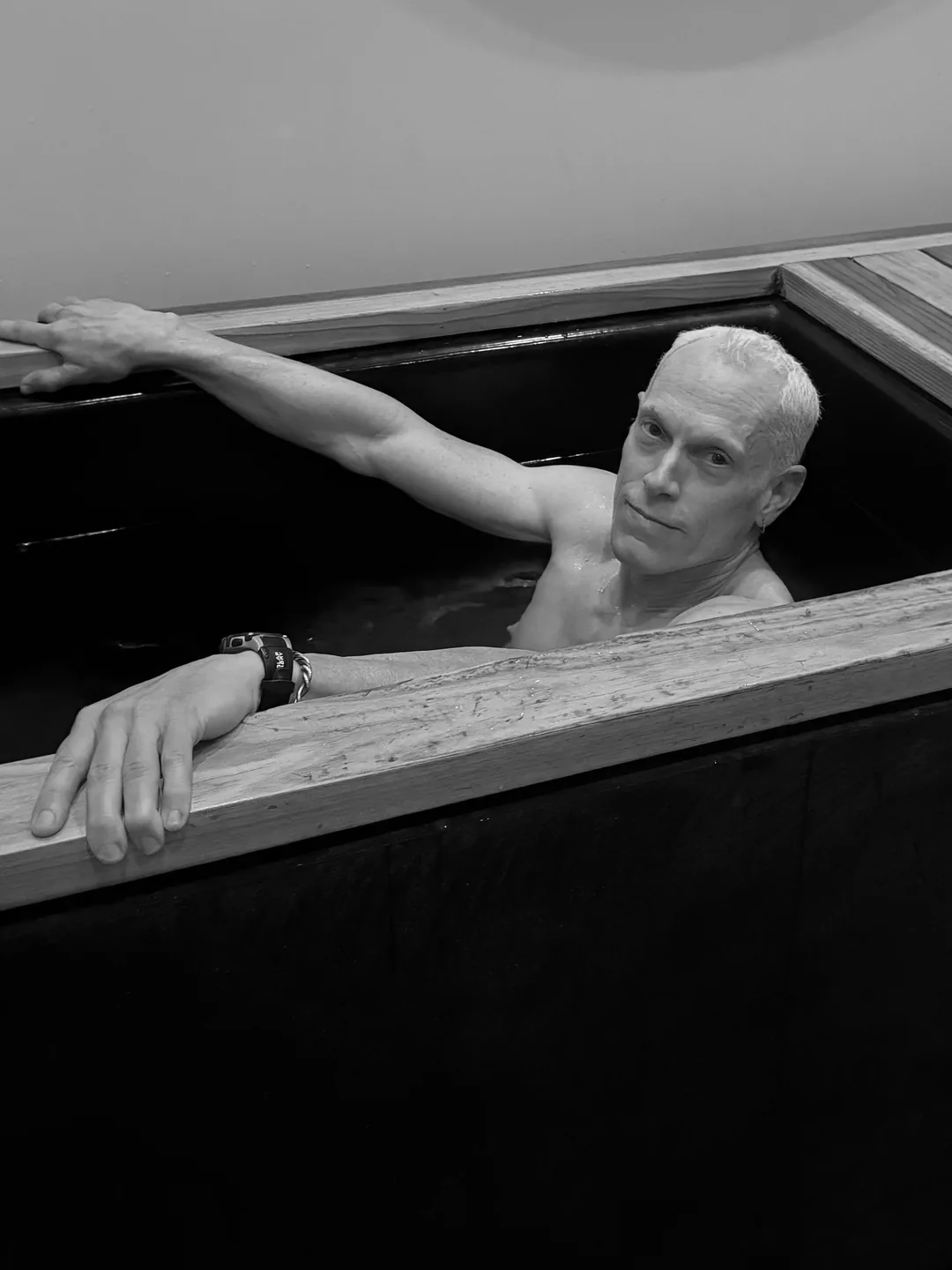 Rick Scott in a cold plunge, black and white