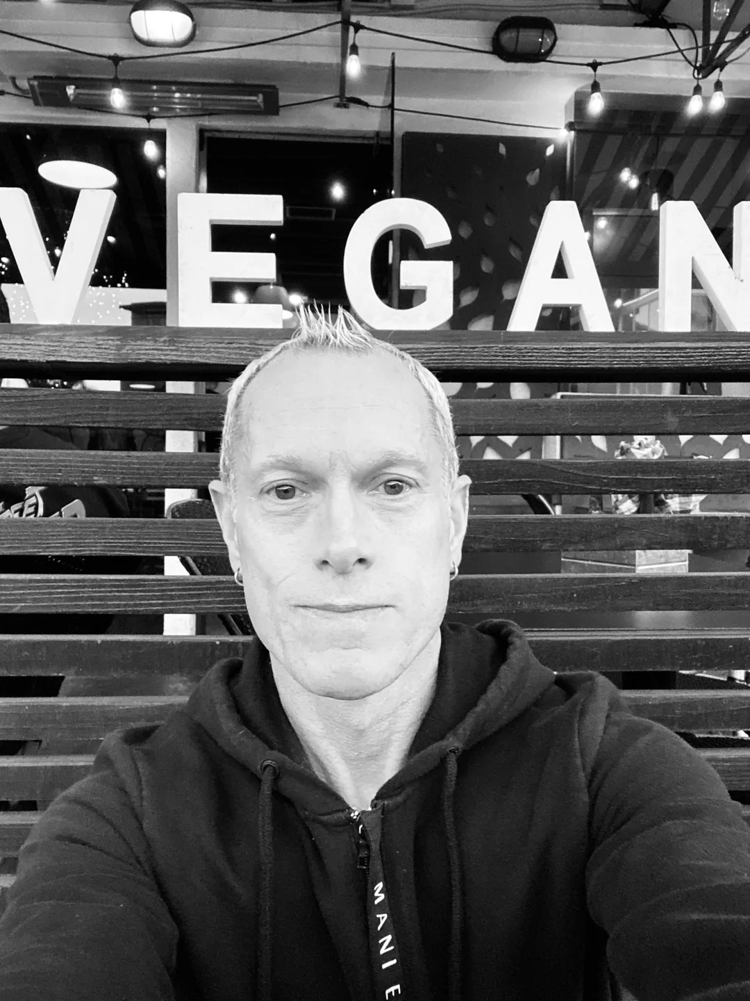 Rick Scott in front of a VEGAN sign